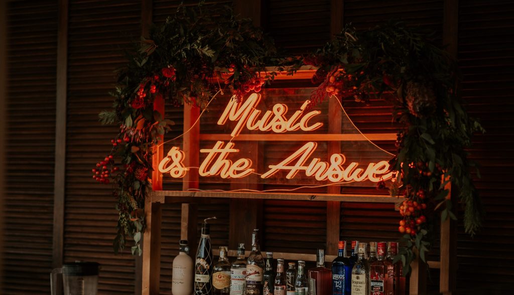 music is the answer neon writing behind bar